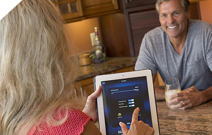 Woman remotely adjusting the hot tub temperature using an app on her tablet