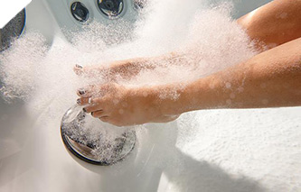 Woman enjoying a relaxing foot massage in hot tub